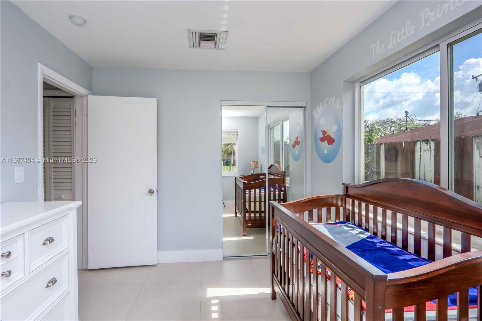 9275 Southwest 45th Street Miami, FL 33165 - Photo 15 of 23 a bedroom with furniture and a window