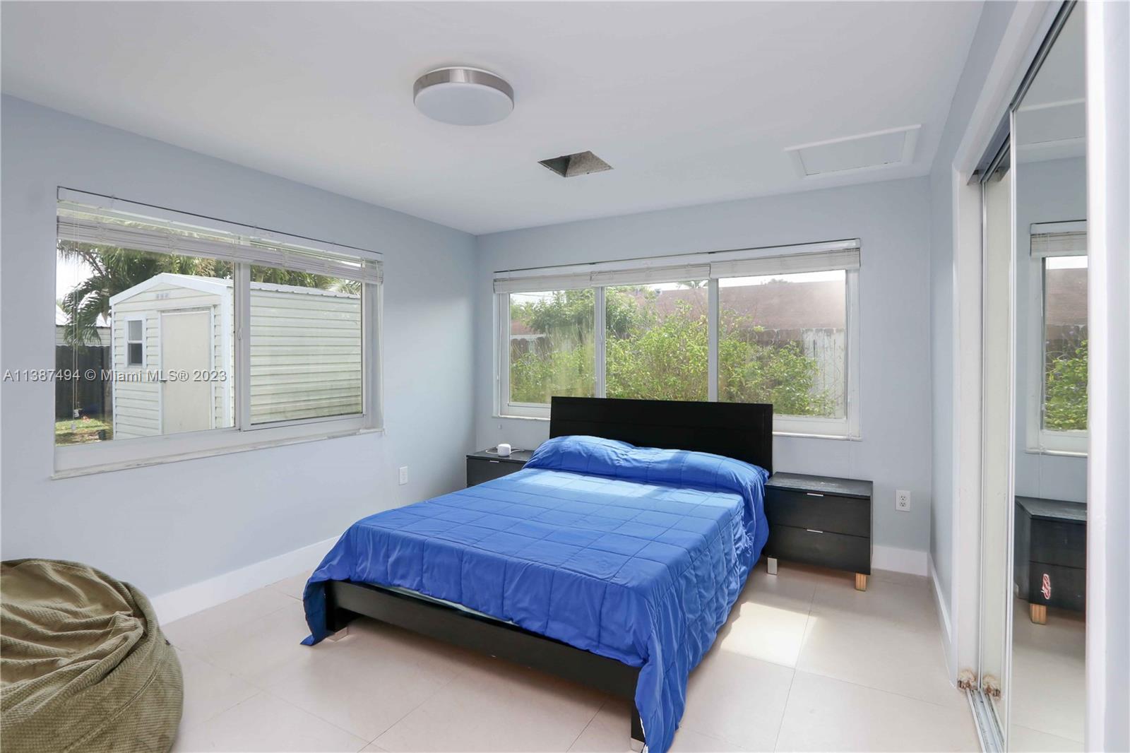 9275 Southwest 45th Street Miami, FL 33165 - Photo 17 of 23 a bedroom with a bed and window