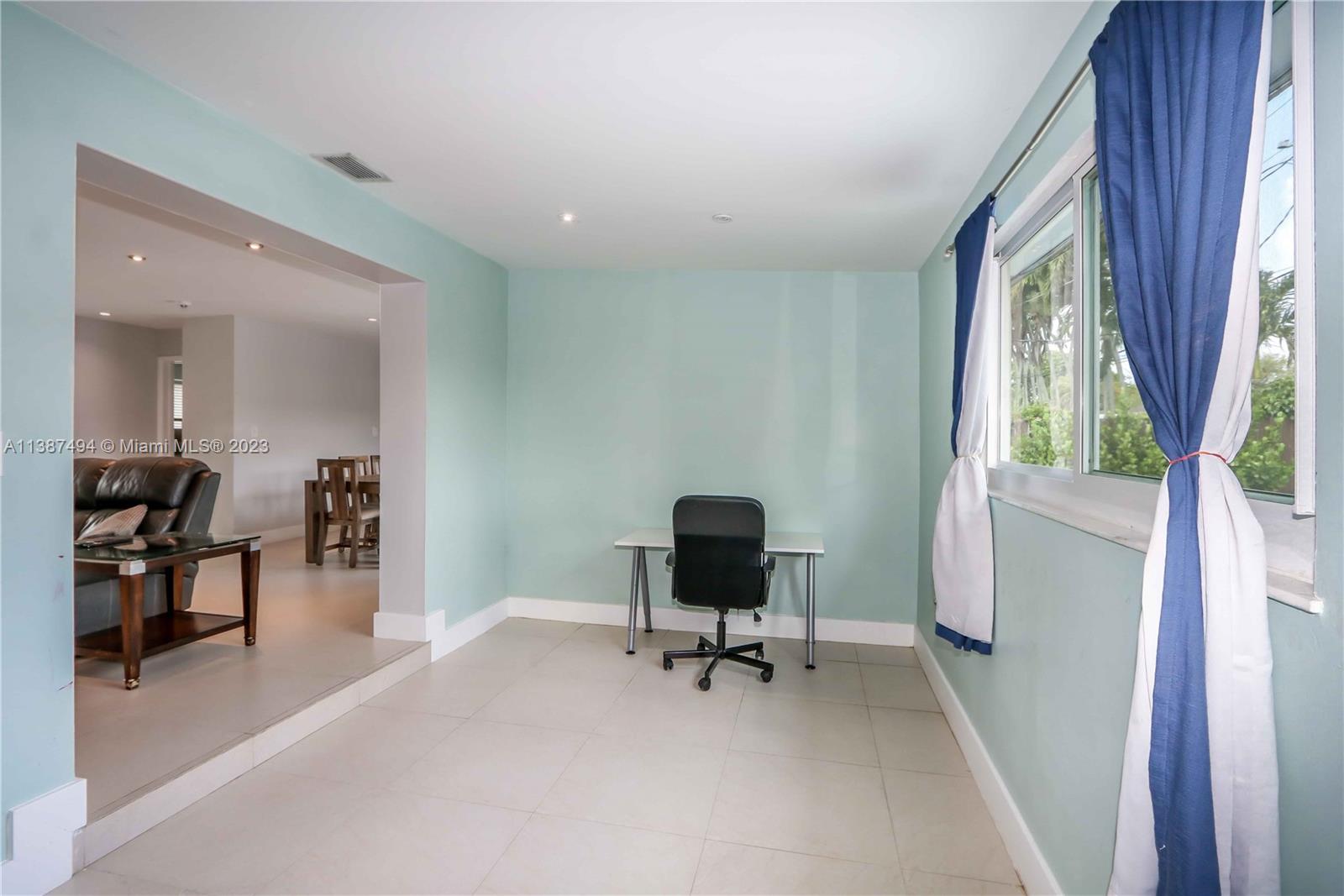 9275 Southwest 45th Street Miami, FL 33165 - Photo 19 of 23 a view of a livingroom with workspace and a window