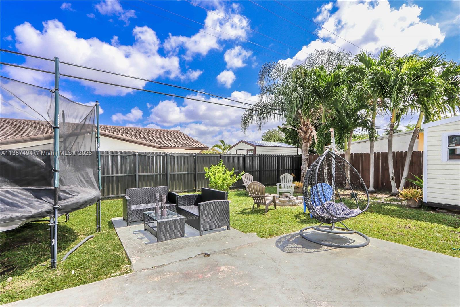 9275 Southwest 45th Street Miami, FL 33165 - Photo 3 of 23 a view of a chair and tables in the patio