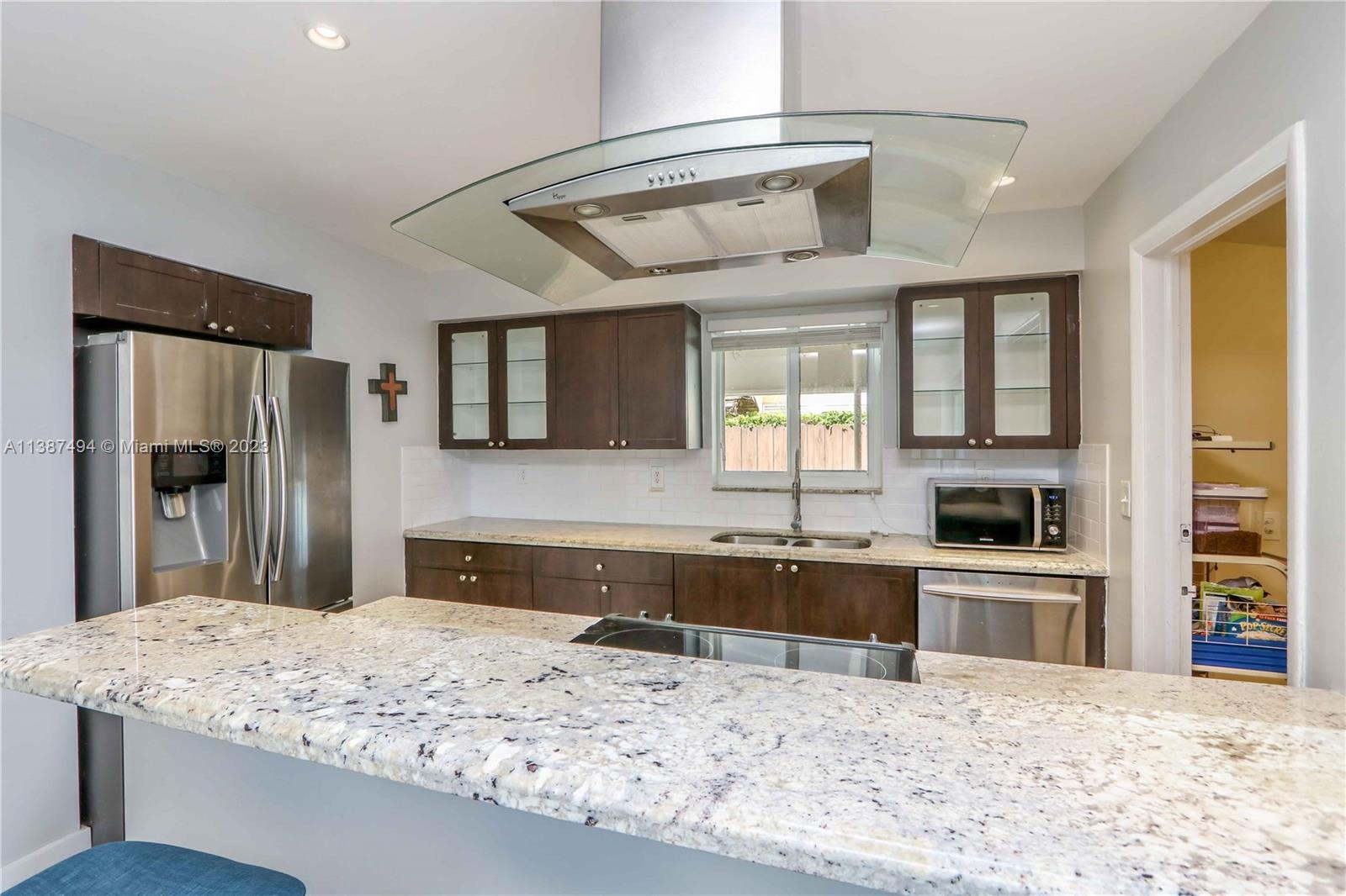 9275 Southwest 45th Street Miami, FL 33165 - Photo 9 of 23 a kitchen with stainless steel appliances granite countertop a refrigerator and a sink