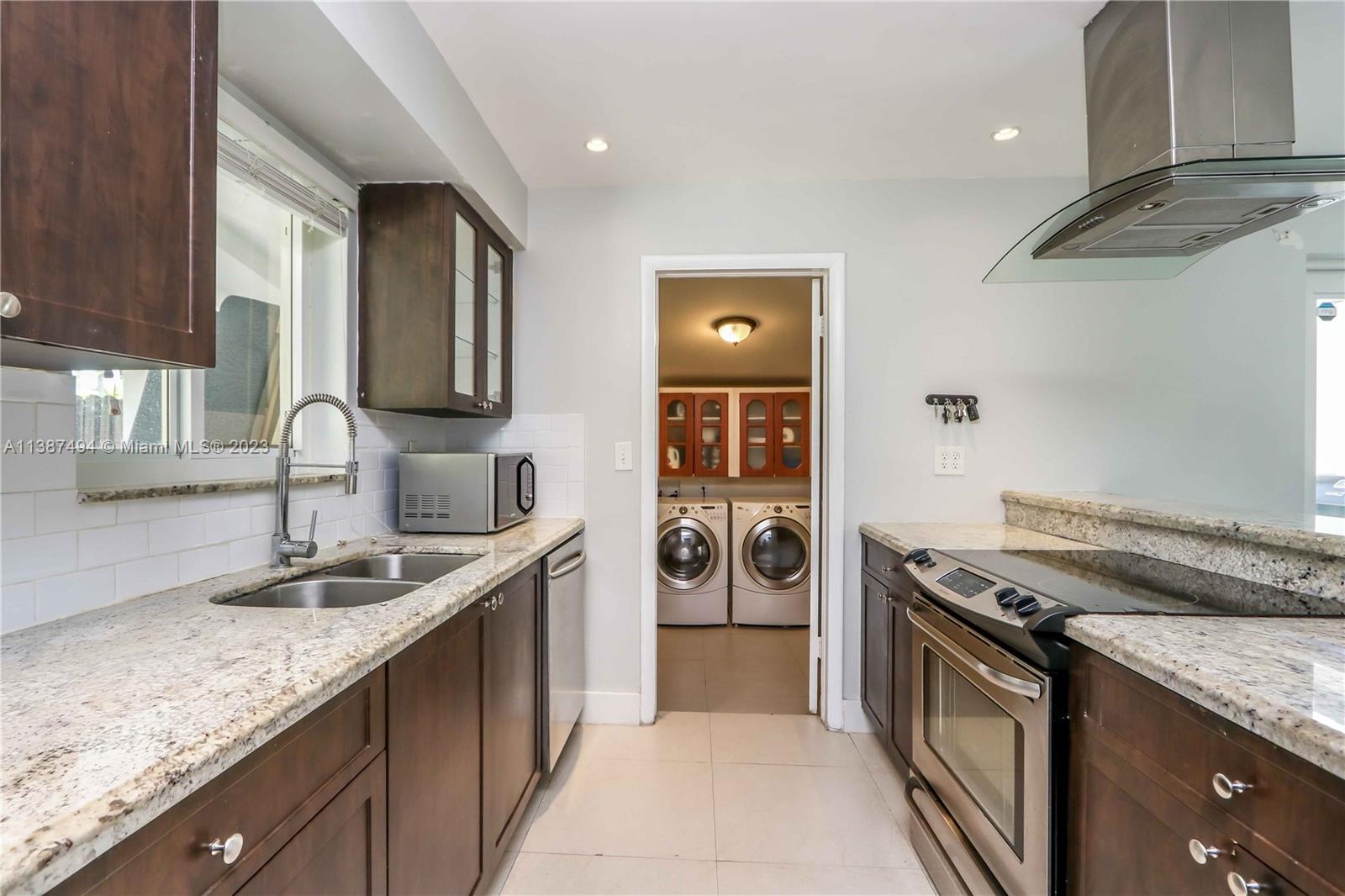 9275 Southwest 45th Street Miami, FL 33165 - Photo 10 of 23 a kitchen with stainless steel appliances granite countertop a sink stove and refrigerator