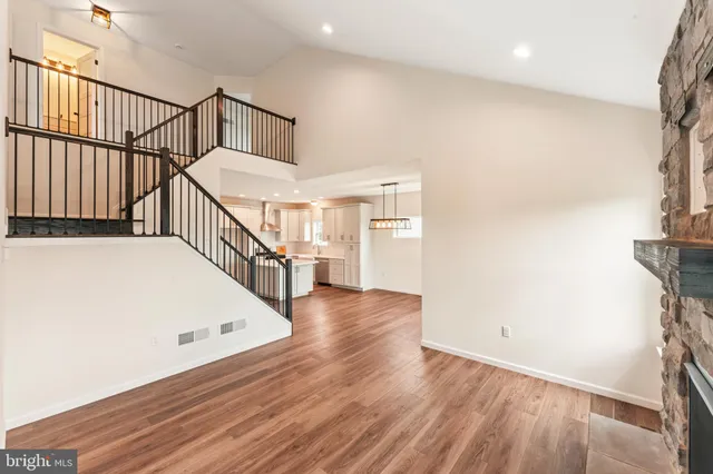 a view of entryway and hall with wooden floor