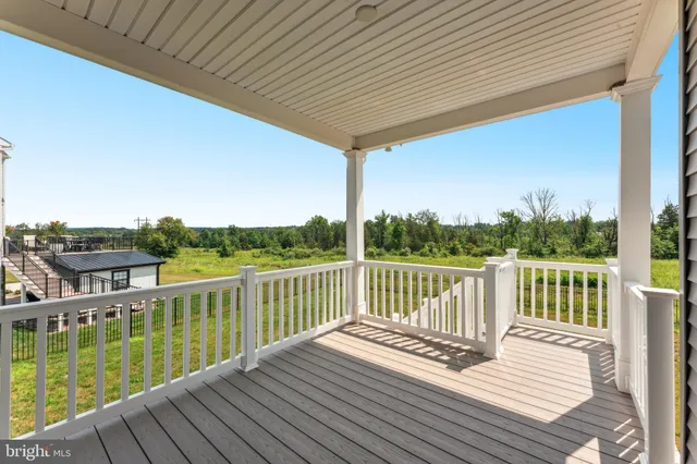a view of balcony with wooden floor and fence