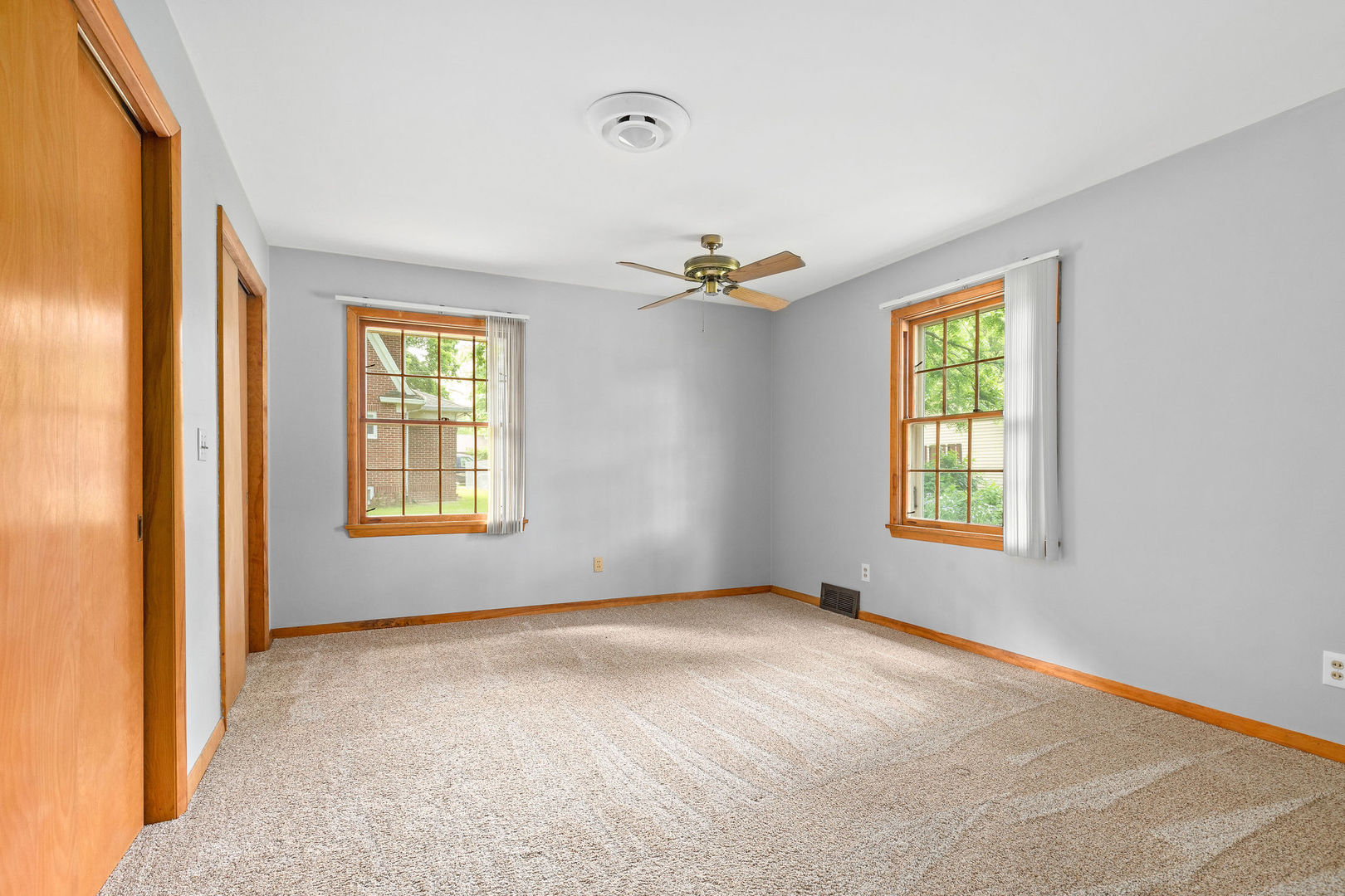 202 Sears Street Plano, IL 60545 - Photo 14 of 32 an empty room with windows and closet