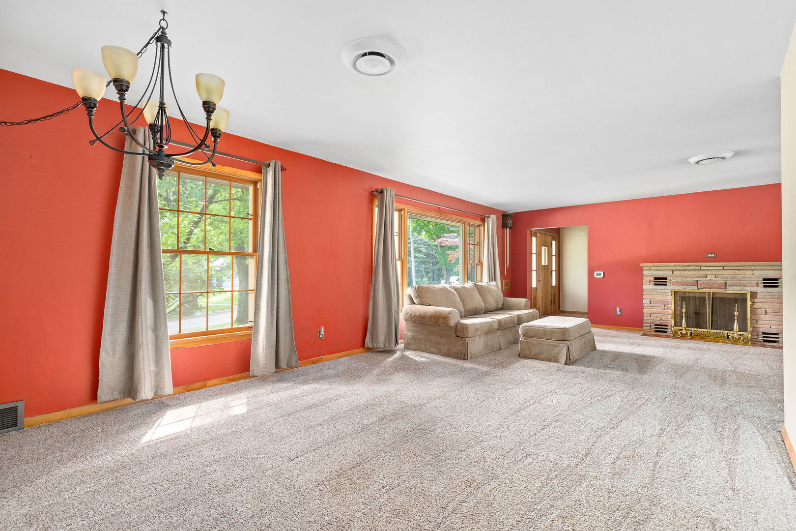 202 Sears Street Plano, IL 60545 - Photo 20 of 32 a living room with furniture a flat screen tv and floor to ceiling window