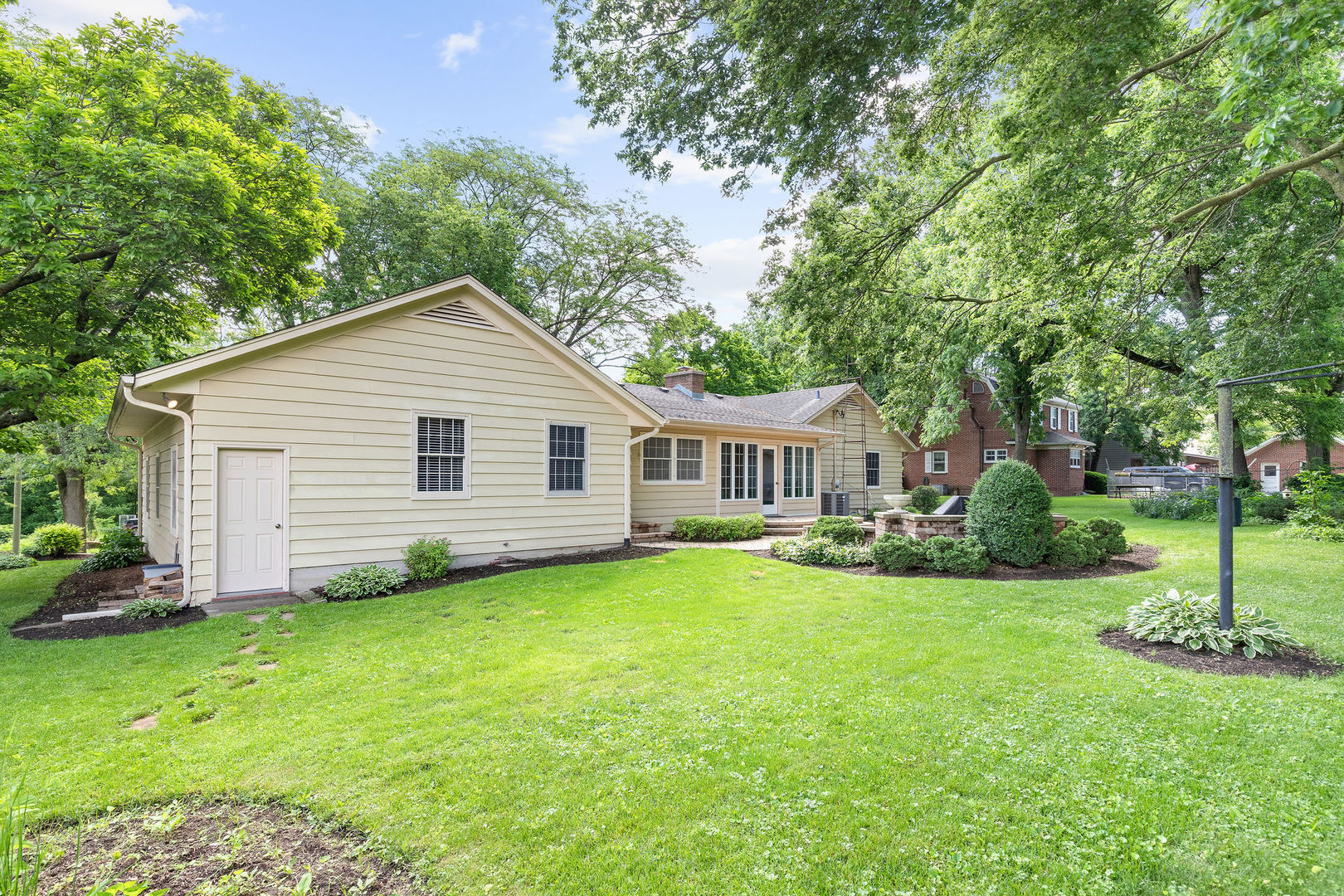 202 Sears Street Plano, IL 60545 - Photo 28 of 32 a view of a house next to a big yard and large trees