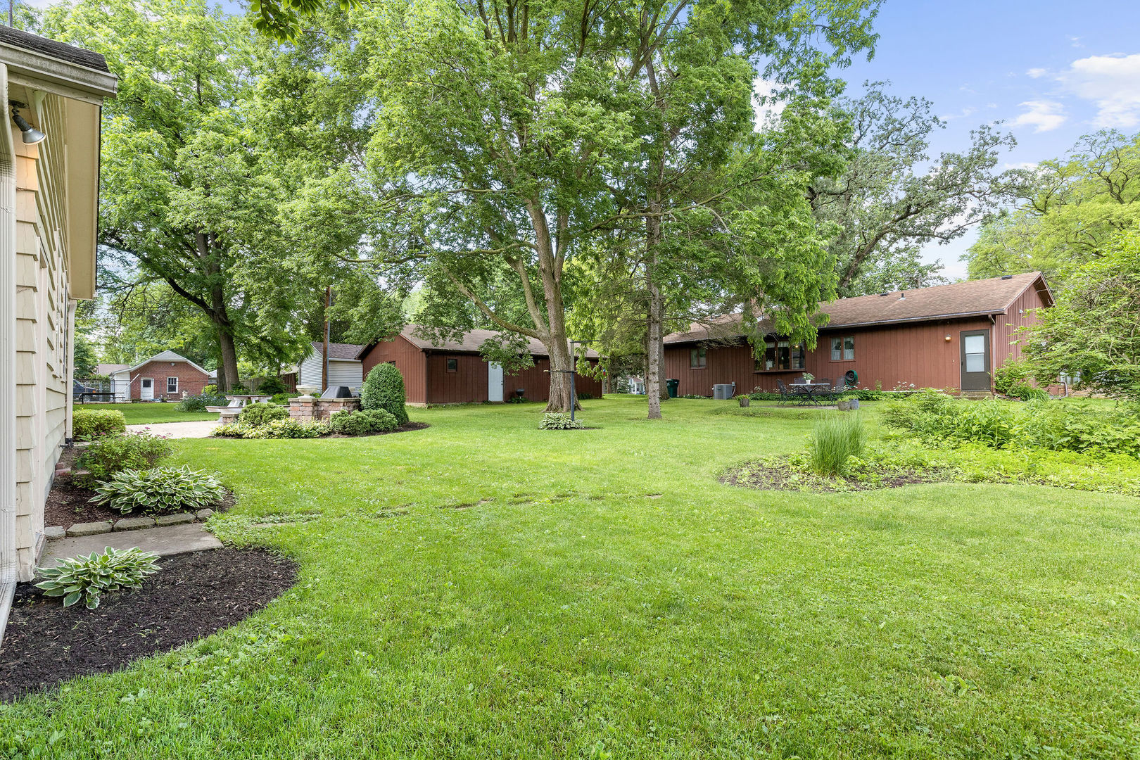 202 Sears Street Plano, IL 60545 - Photo 30 of 32 a view of a house with backyard and a tree