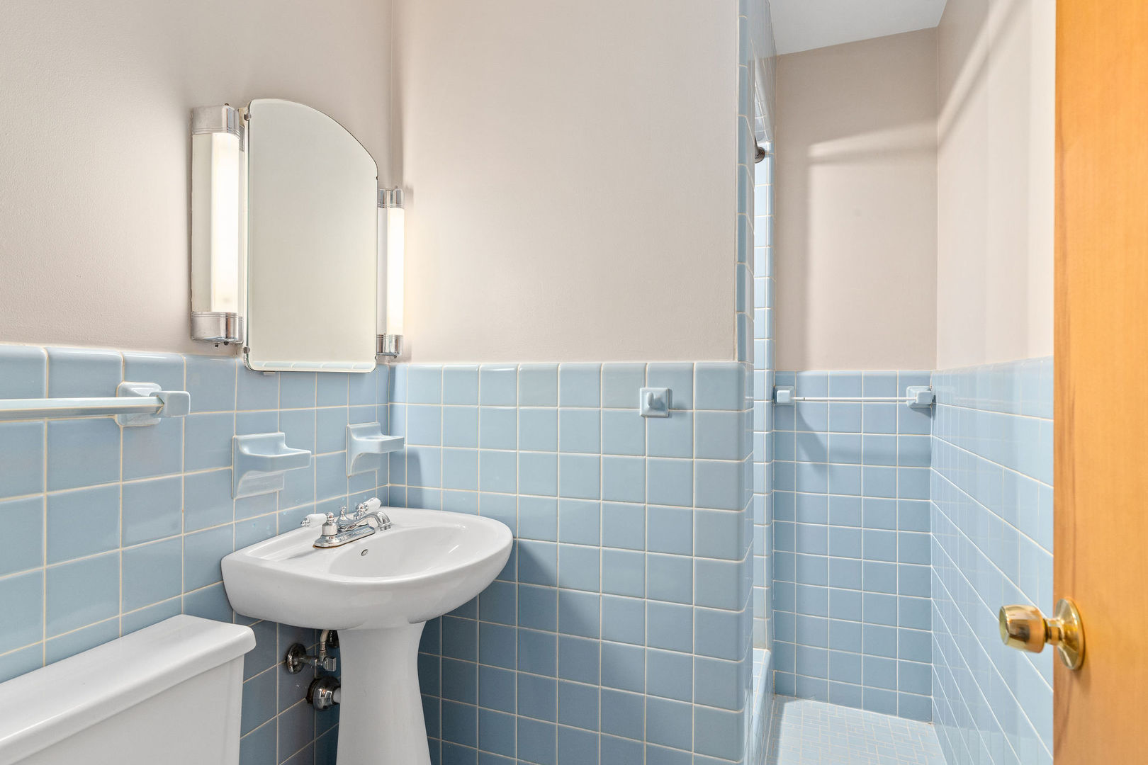 202 Sears Street Plano, IL 60545 - Photo 4 of 32 a bathroom with a sink a mirror and shower