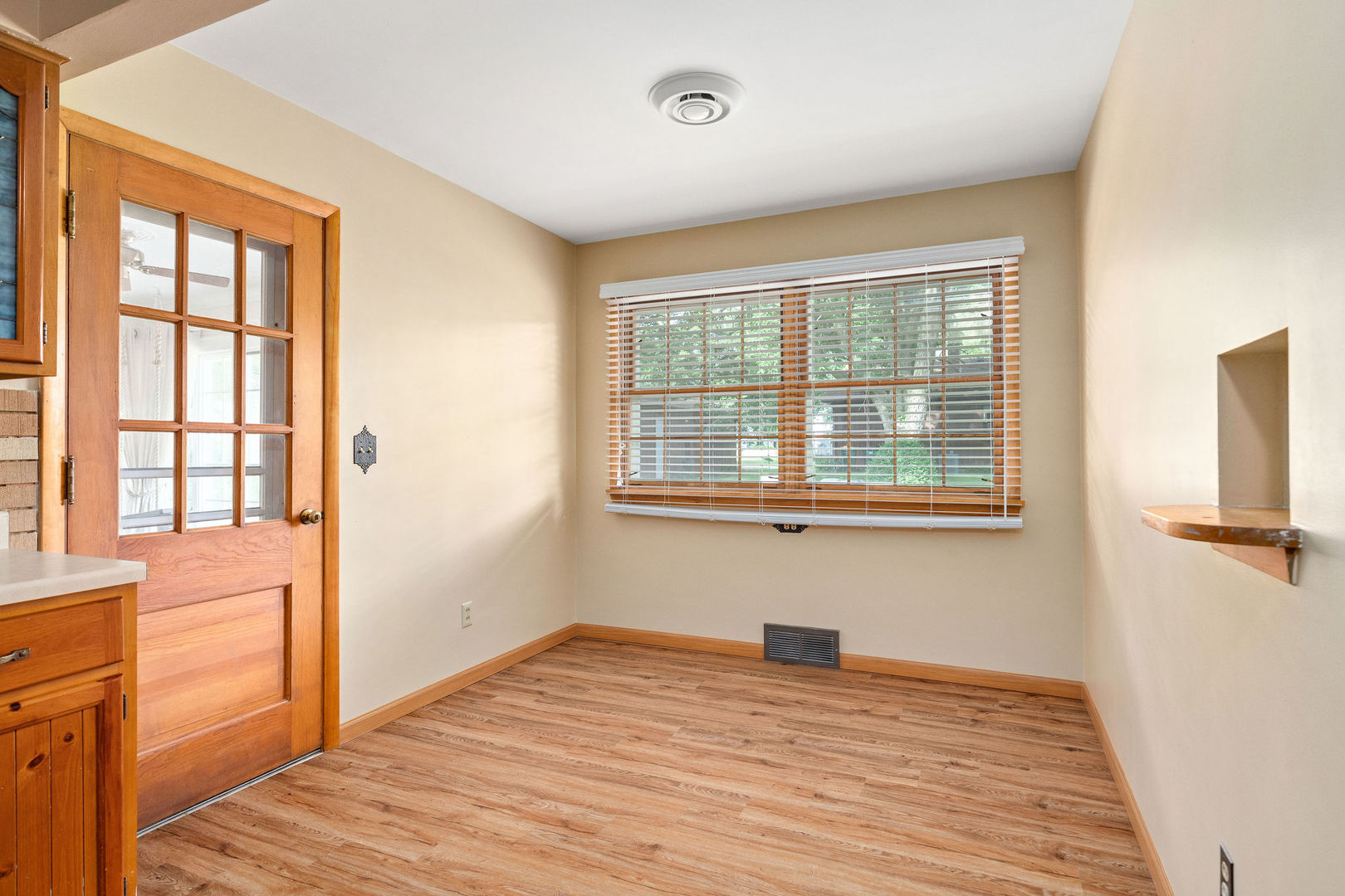 202 Sears Street Plano, IL 60545 - Photo 7 of 32 a view of empty room with wooden floor and fan