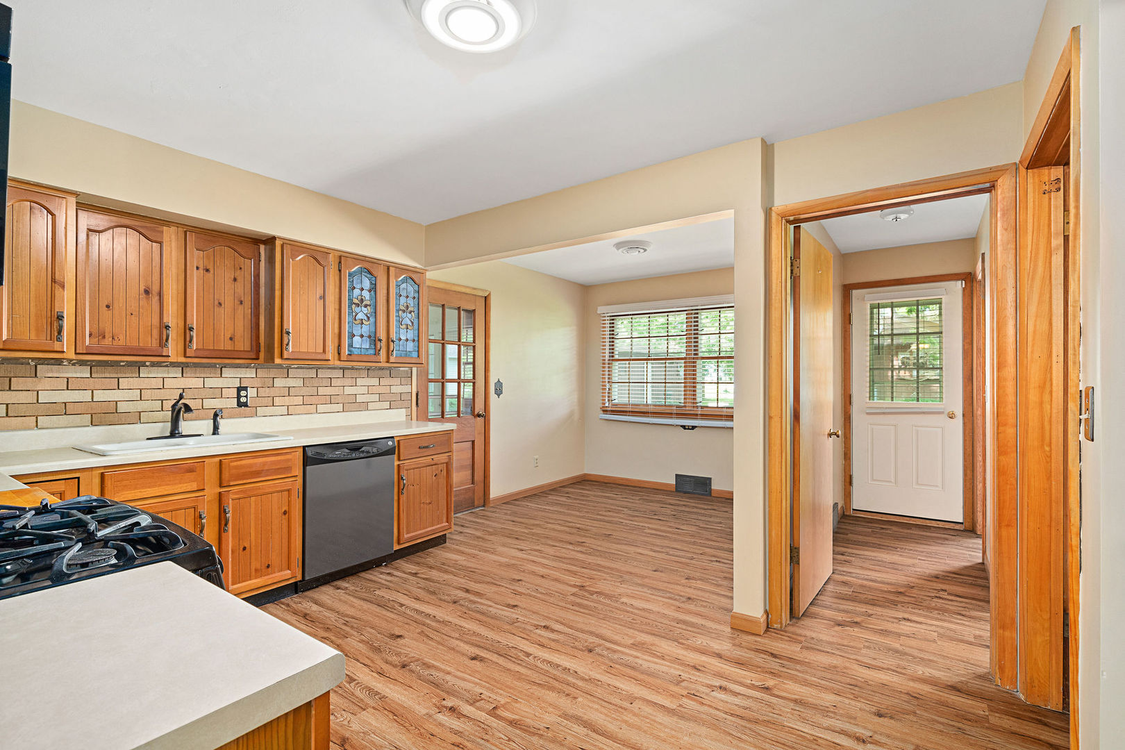 202 Sears Street Plano, IL 60545 - Photo 10 of 32 a kitchen with stainless steel appliances granite countertop a sink stove and wooden cabinets
