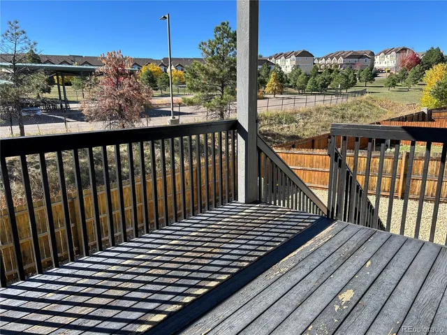 a view of a balcony with wooden floor
