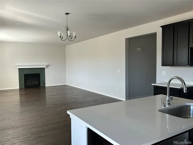 a kitchen with a sink a counter space and cabinets