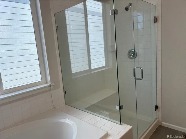 a bathroom with a bathtub and shower