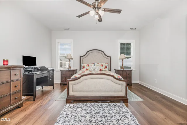 a kitchen with stainless steel appliances a dining table chairs stove and white cabinets