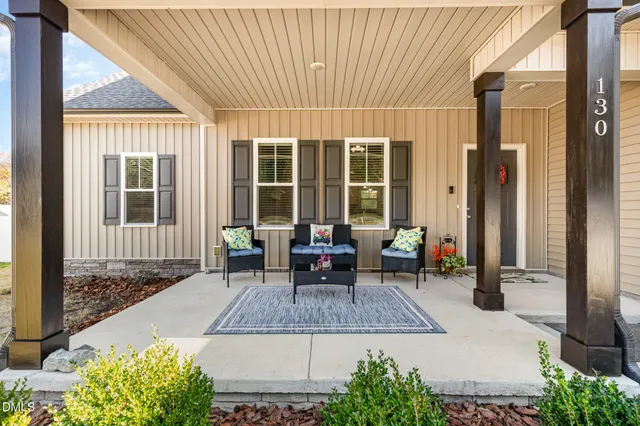 a view of a house with sitting area and garden