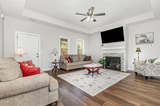 a living room with furniture and wooden floor
