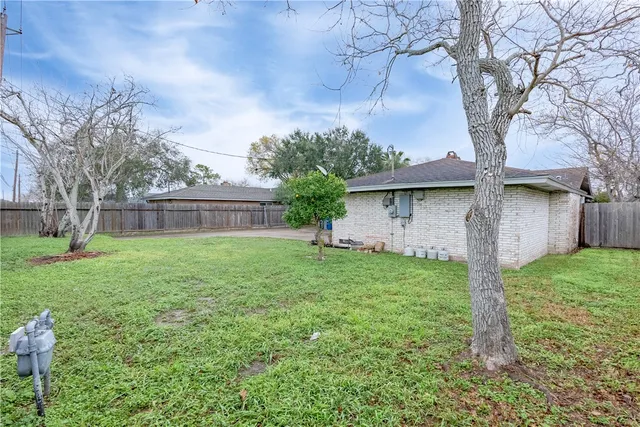 a view of a house with yard and a tree