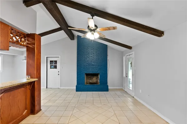a view of a livingroom with stairs and a fireplace