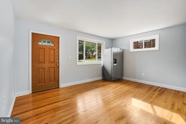 a view of a kitchen with wooden floor and a ceiling fan