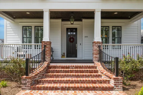 a front view of a house with a yard table and chairs
