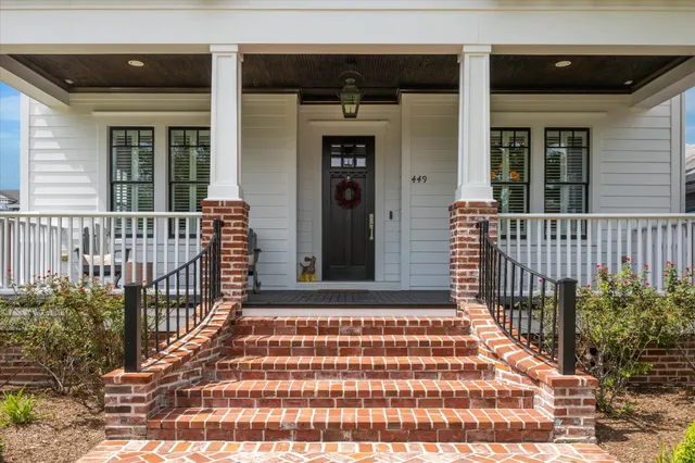 a front view of a house with a yard table and chairs