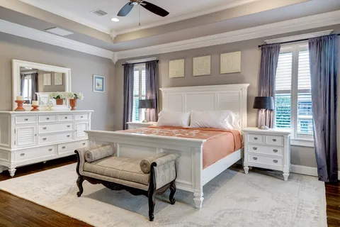 a dining room with furniture a chandelier and wooden floor