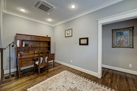 a bedroom with a large bed a chandelier and a book shelf