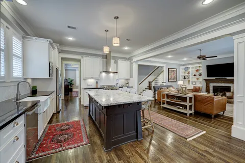 a view of a balcony with a potted plant and wooden floor