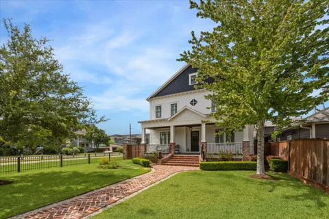 a view of a patio with a table chairs and wooden fence