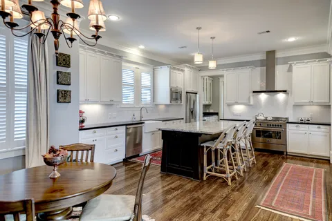 a large kitchen with stainless steel appliances granite countertop a stove and a refrigerator