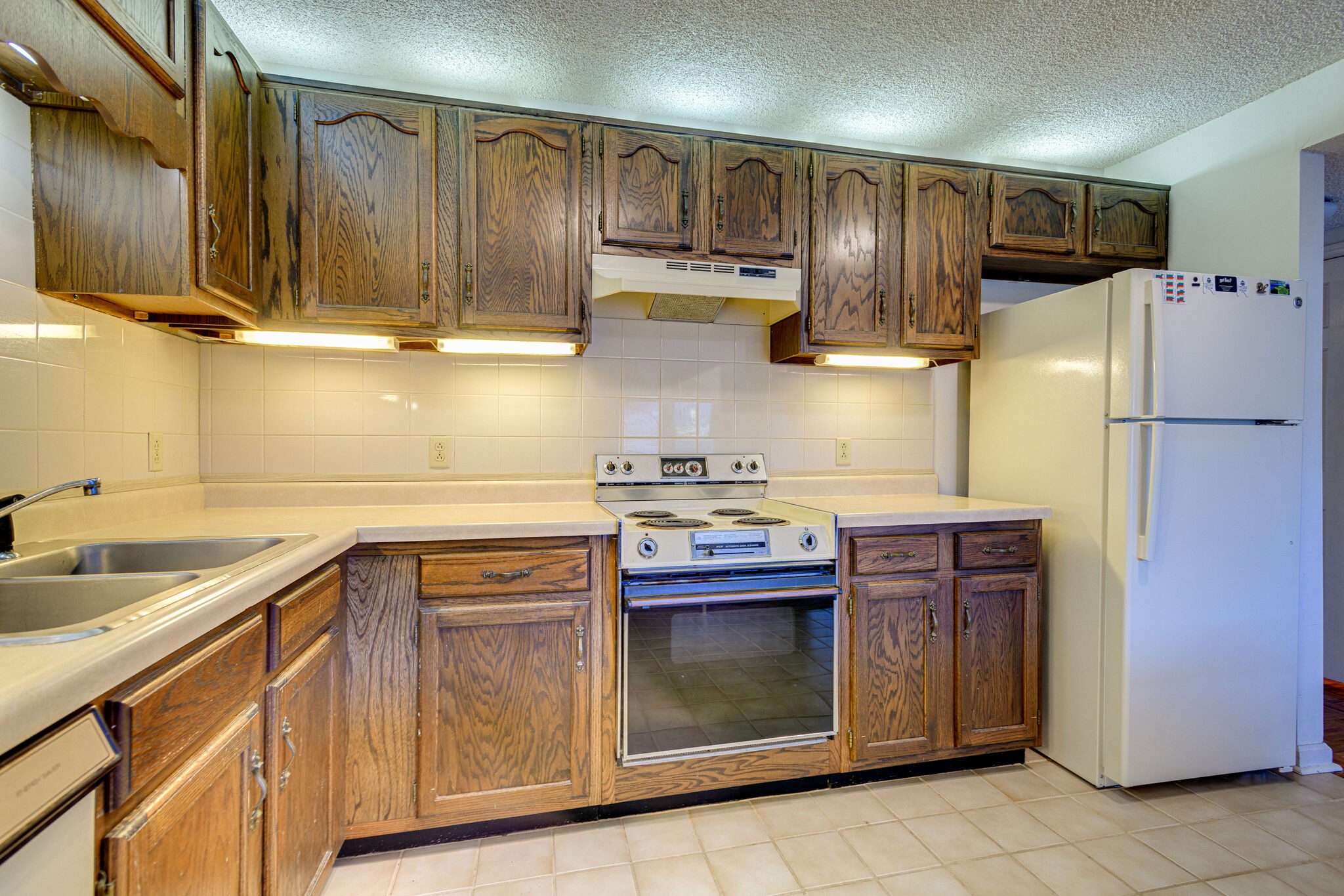4001 Anderson Road, Unit J19 Nashville, TN 37217 - Photo 11 of 37 a kitchen with stainless steel appliances granite countertop a refrigerator sink and stove