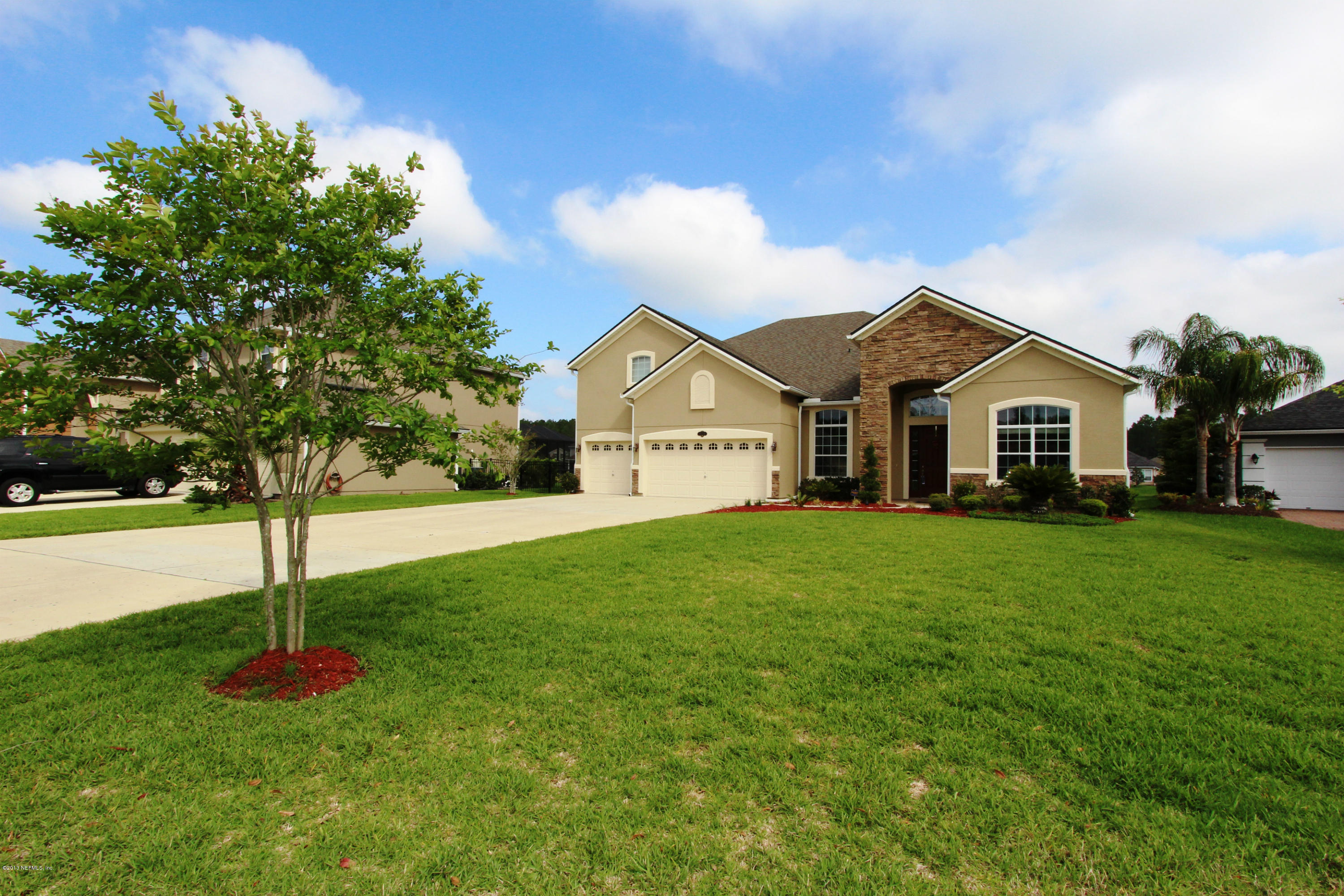 a view of a house with a yard and tree s
