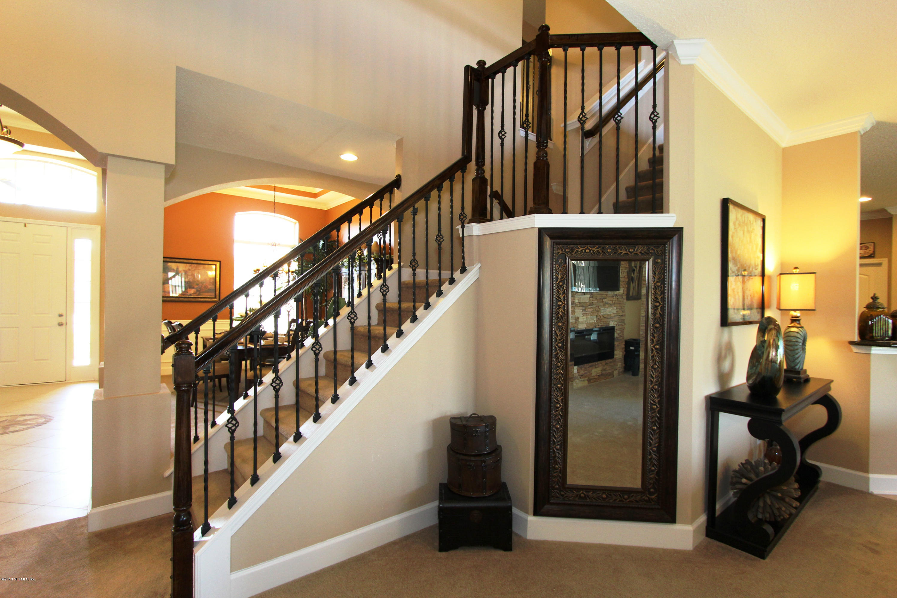 732 Castledale Court Jacksonville, FL 32259 - Photo 11 of 50 a view of staircase with wooden floor and a chandelier