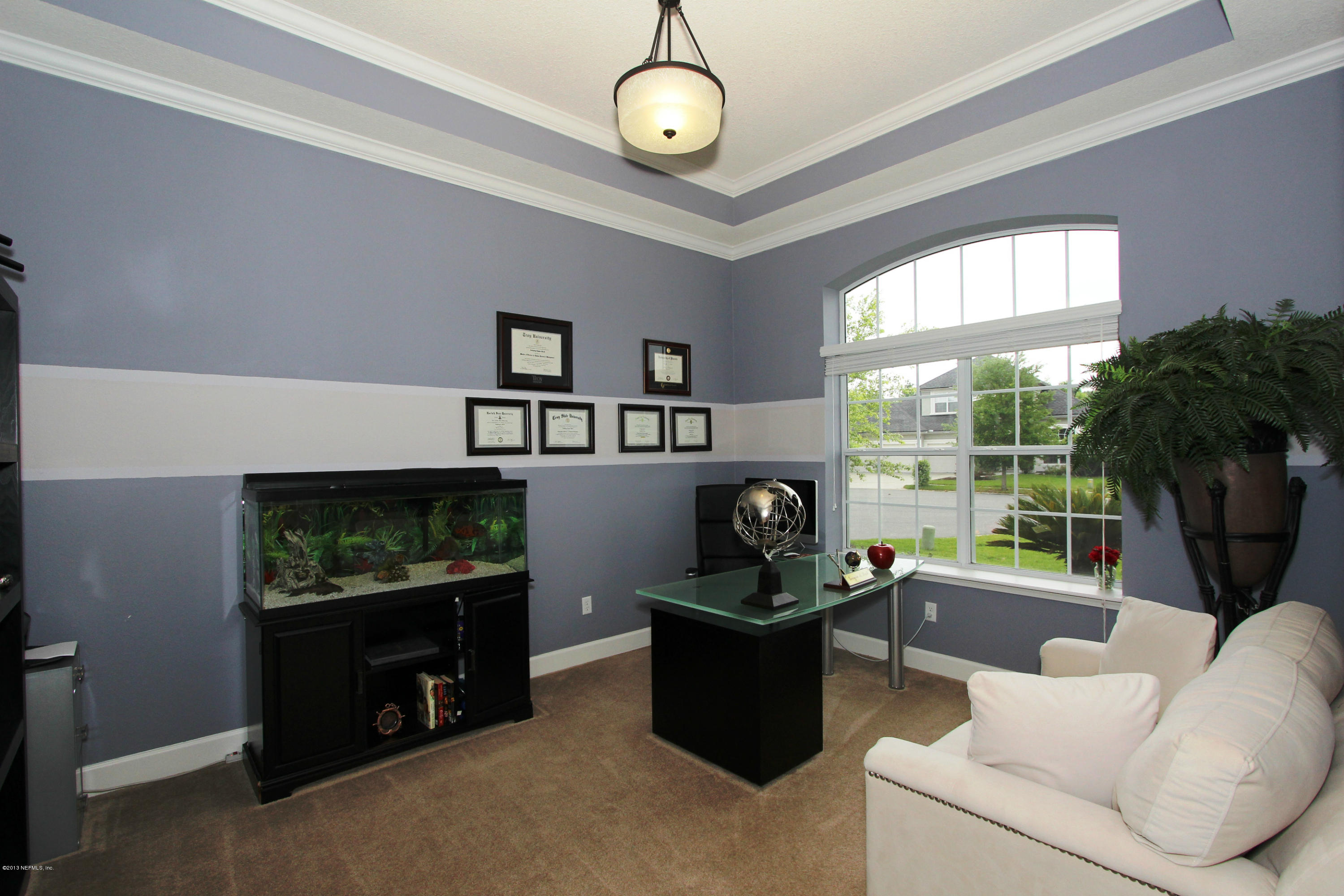 732 Castledale Court Jacksonville, FL 32259 - Photo 12 of 50 a living room with furniture a window and a flat screen tv