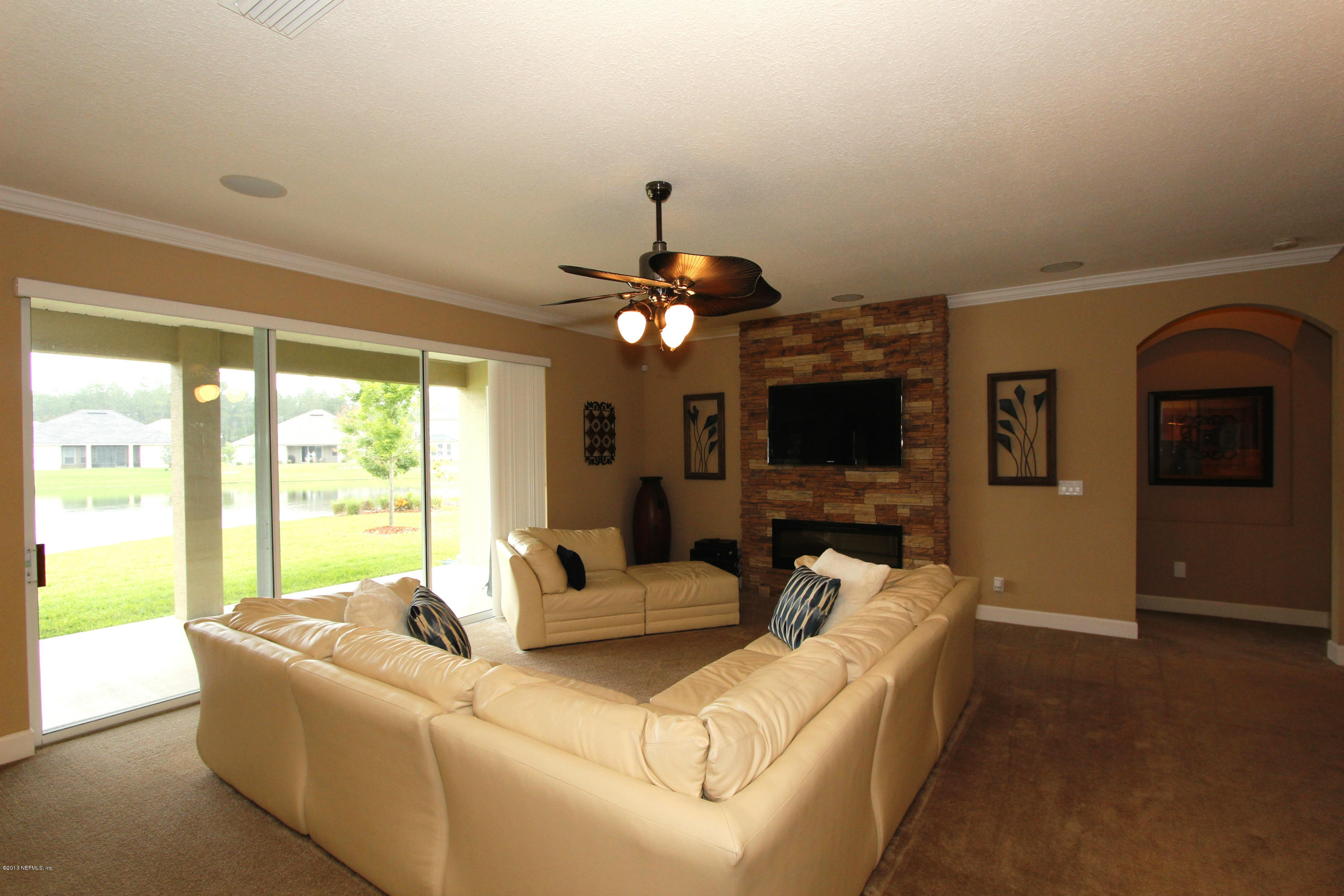 732 Castledale Court Jacksonville, FL 32259 - Photo 16 of 50 a living room with furniture a flat screen tv and a large window