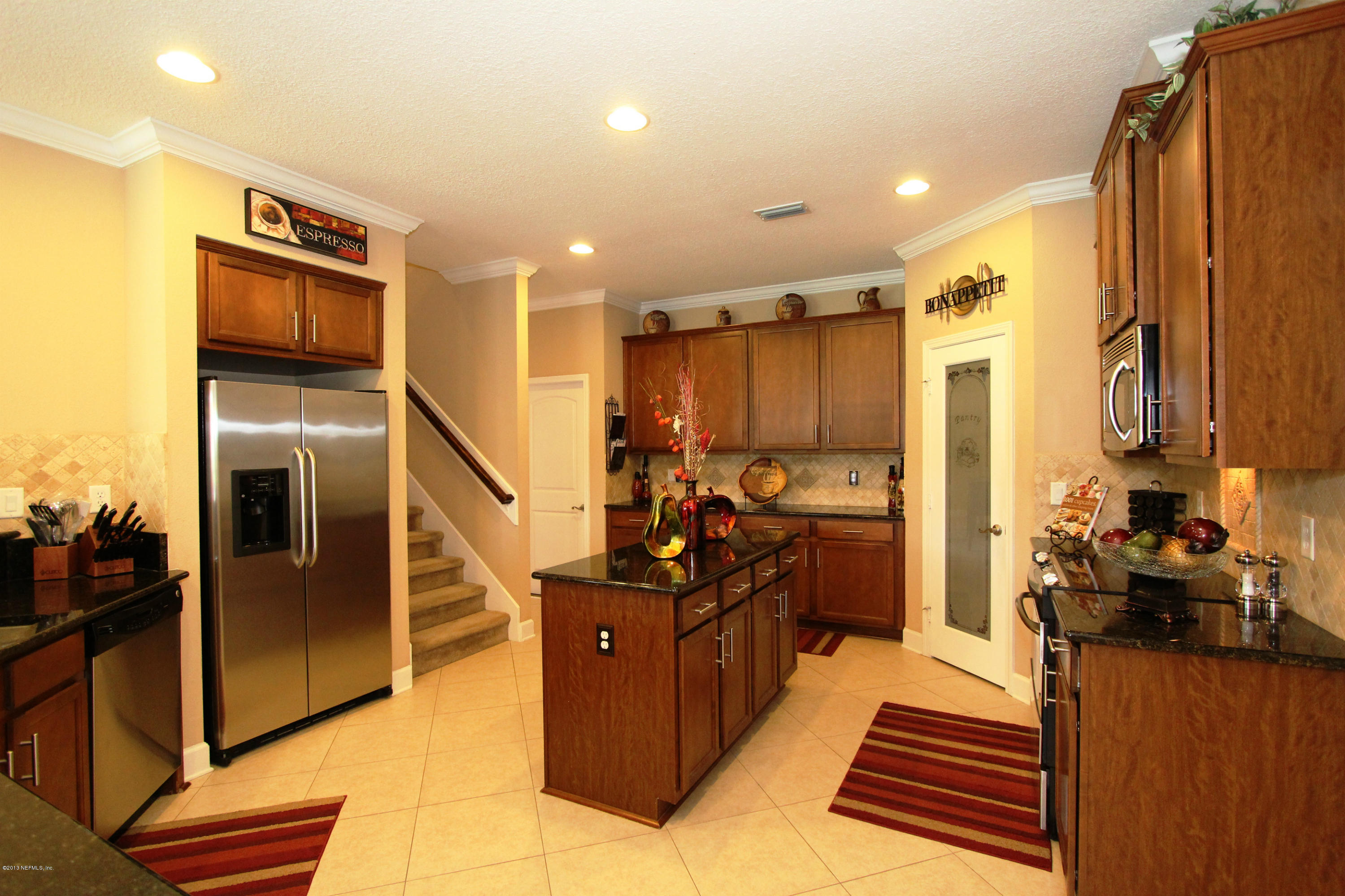 732 Castledale Court Jacksonville, FL 32259 - Photo 18 of 50 a view of a kitchen with stainless steel appliances kitchen island granite countertop a refrigerator and a stove top oven