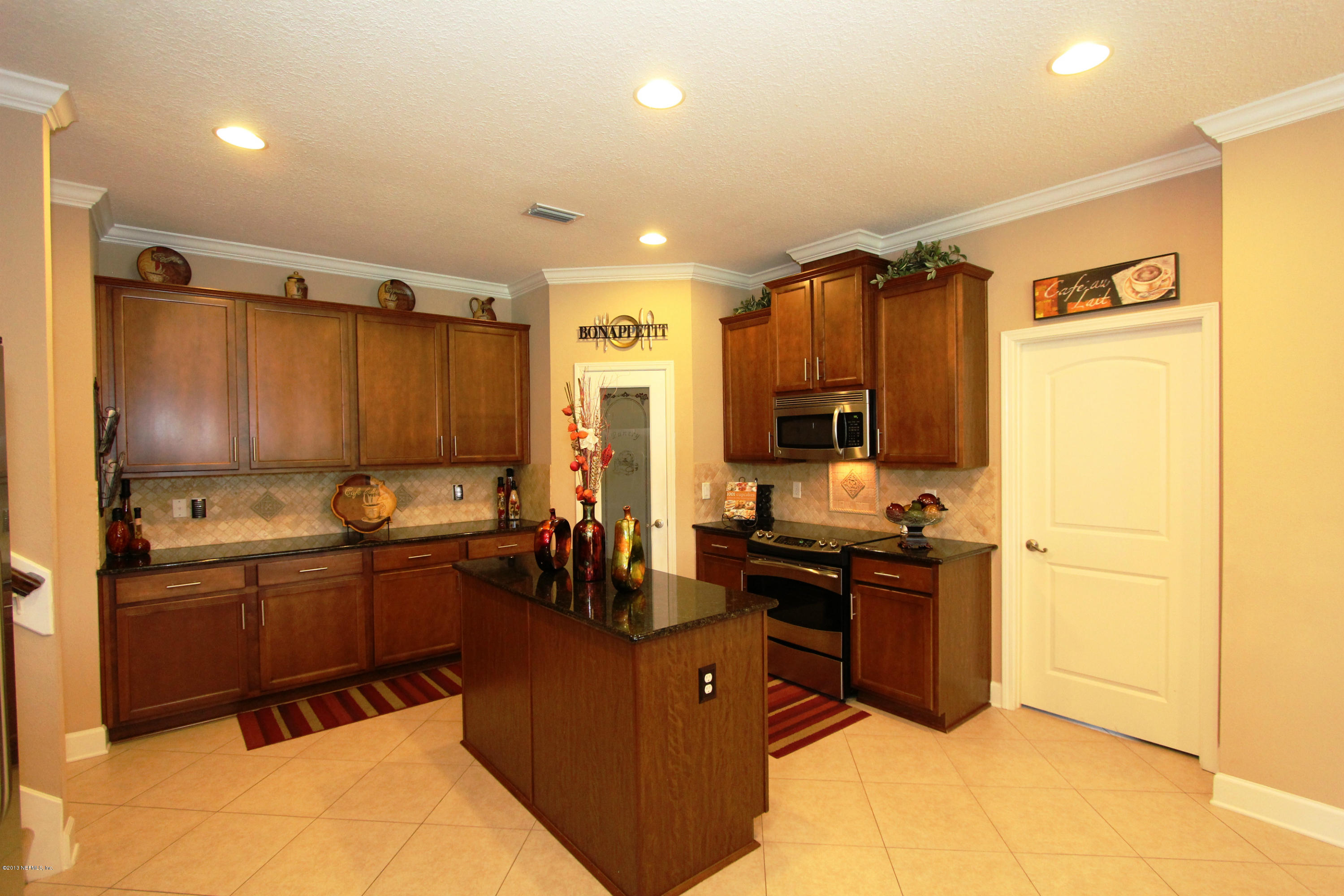 732 Castledale Court Jacksonville, FL 32259 - Photo 19 of 50 a kitchen with stainless steel appliances granite countertop a sink stove and refrigerator