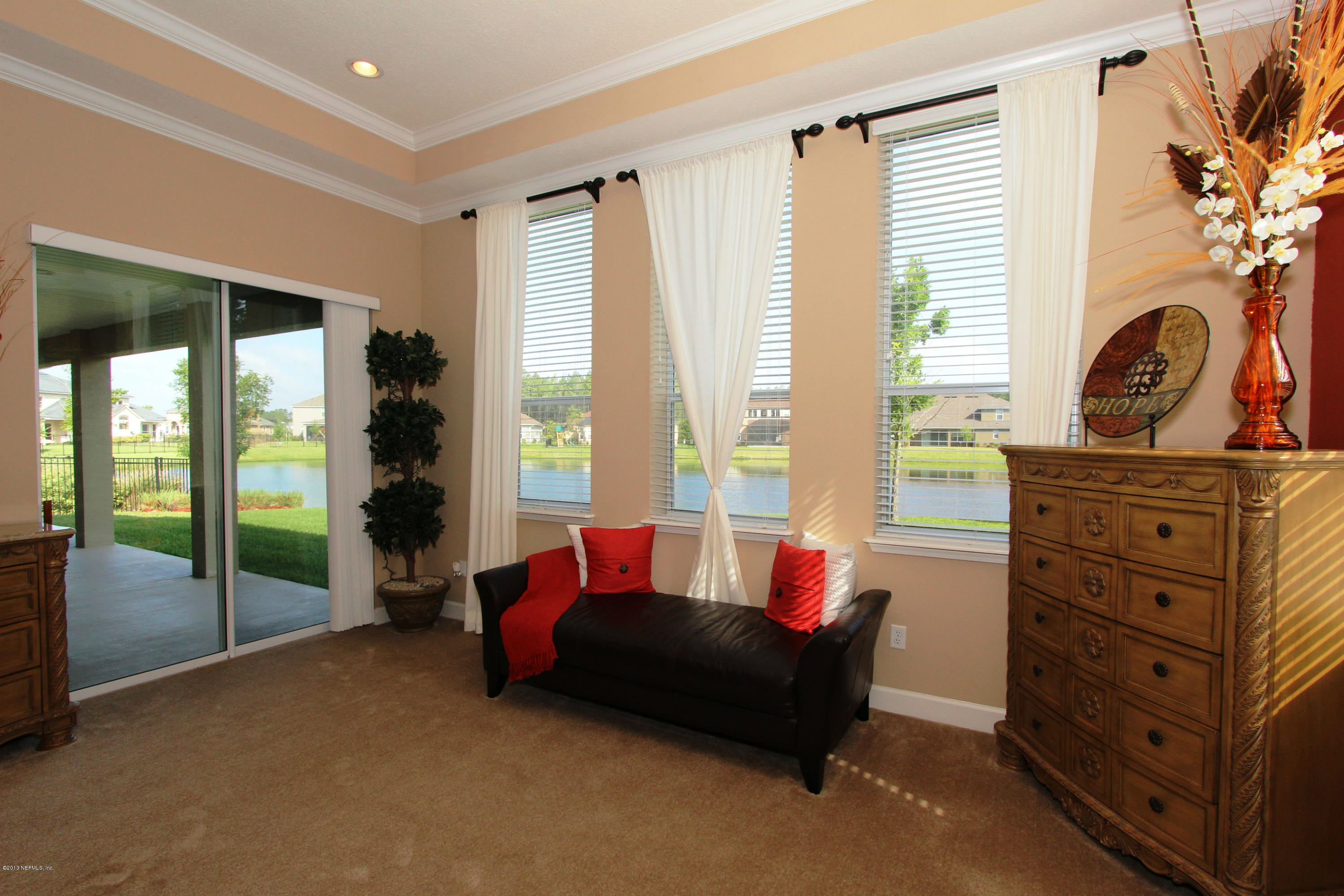 732 Castledale Court Jacksonville, FL 32259 - Photo 26 of 50 a living room with furniture and a floor to ceiling window