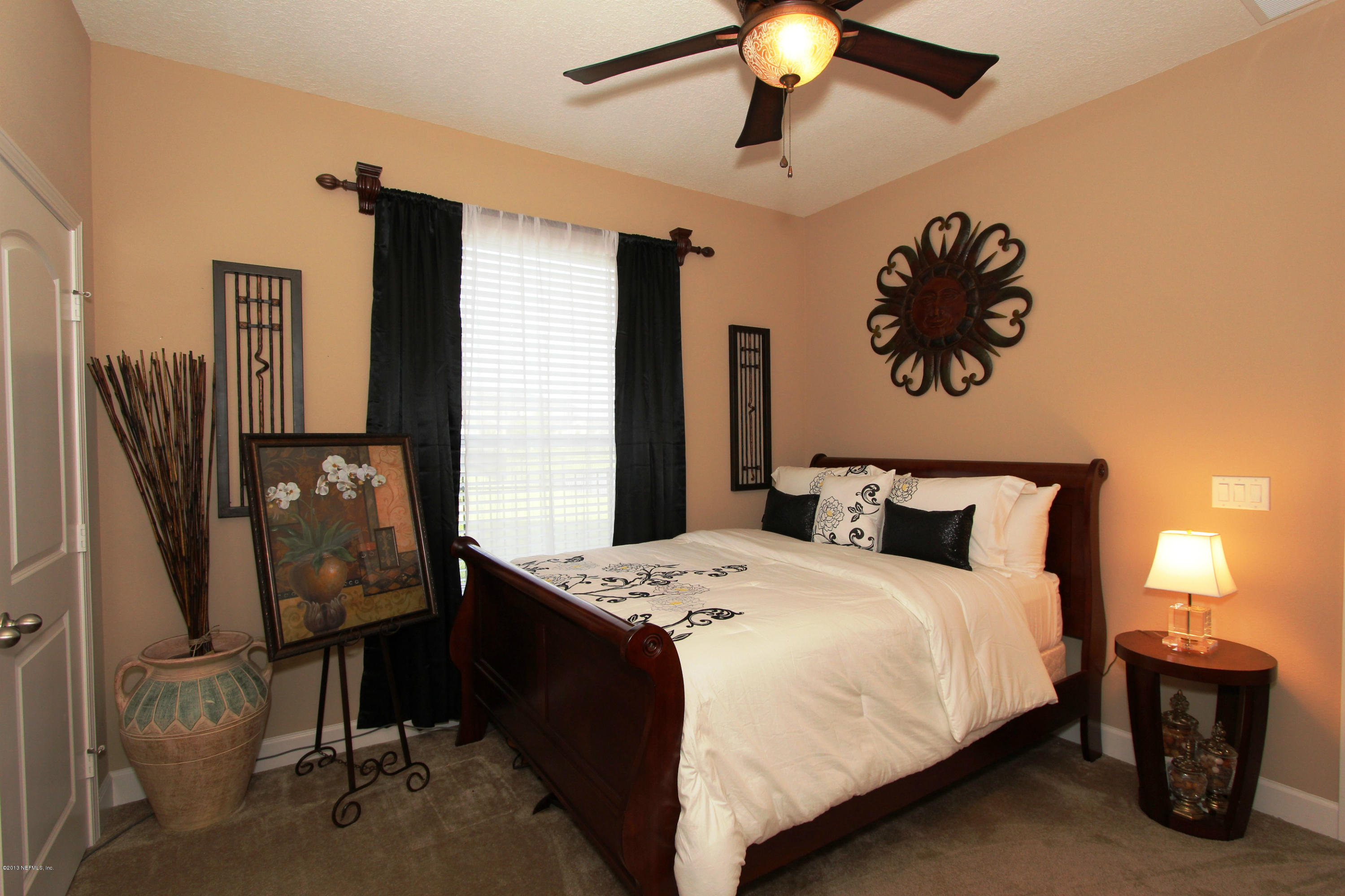 732 Castledale Court Jacksonville, FL 32259 - Photo 29 of 50 a bedroom with a bed and dresser with mirror