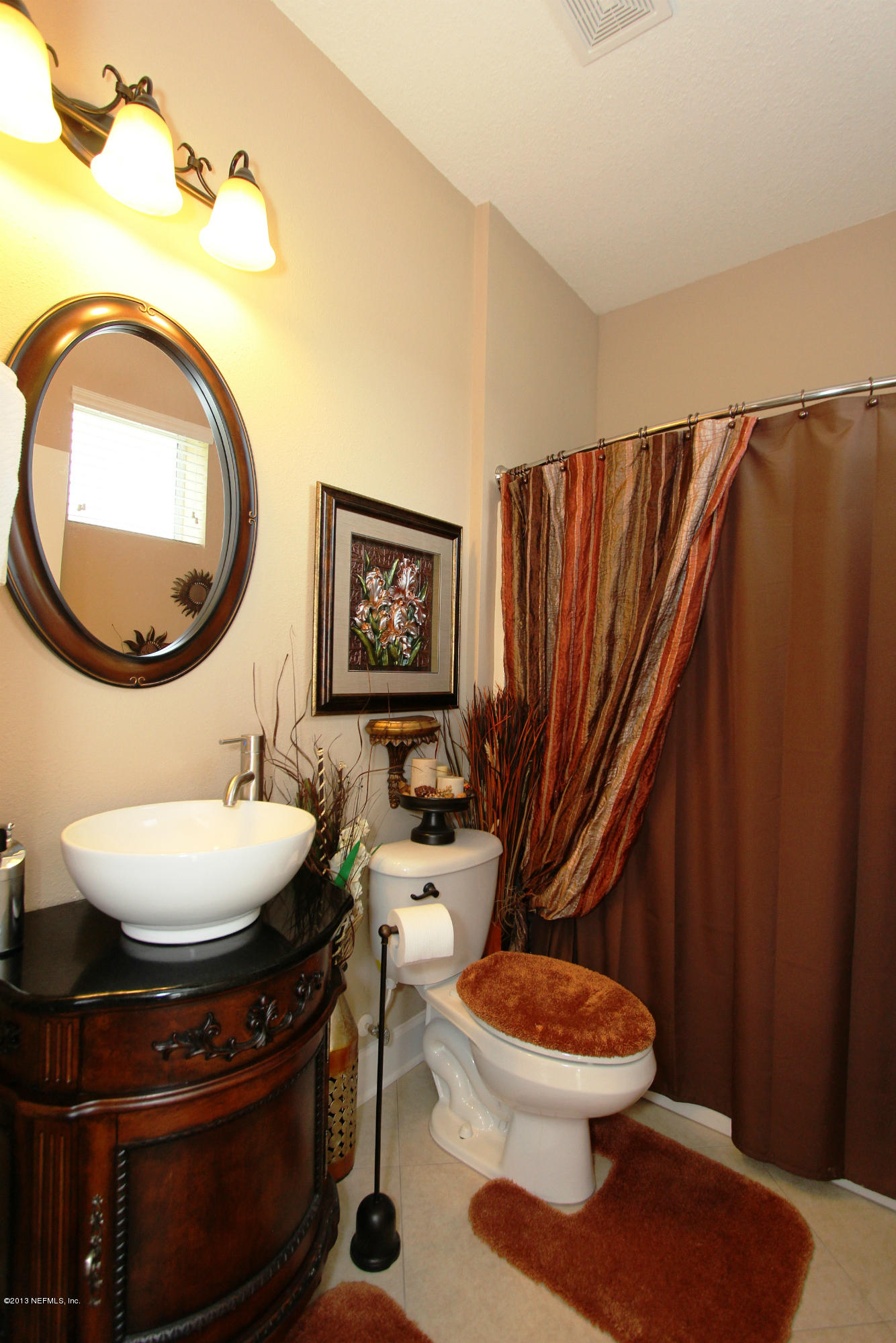 732 Castledale Court Jacksonville, FL 32259 - Photo 31 of 50 a bathroom with a toilet a sink and a mirror