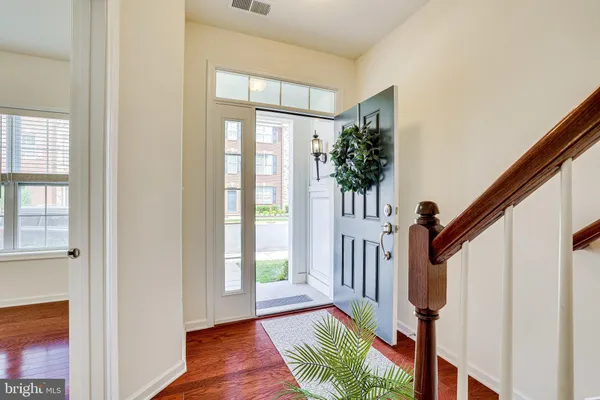 a view of entryway with wooden floor and windows