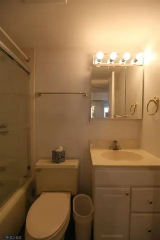 a bedroom with a bed window and a couch