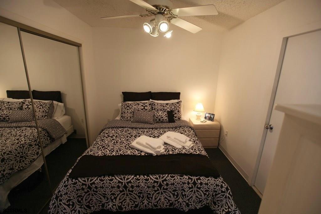 111 South 16th Avenue, Unit 312 Longport, NJ 08403 - Photo 12 of 14 a bedroom with a bed window and a couch