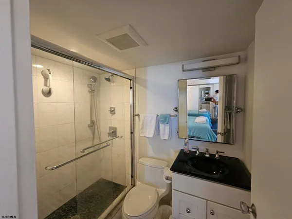a bathroom with a sink and shower