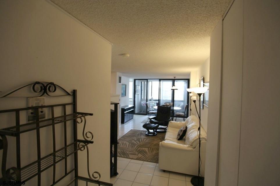 111 South 16th Avenue, Unit 312 Longport, NJ 08403 - Photo 3 of 14 a living room with furniture a couch and a floor to ceiling window