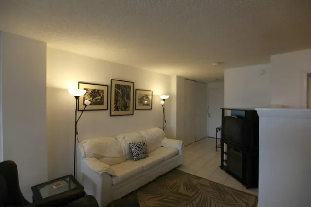 a dining room with furniture a chandelier and wooden floor