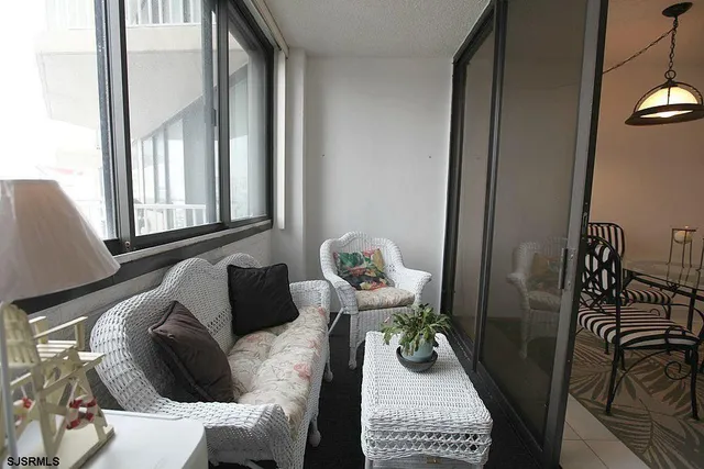 a living room with furniture flowerpot and window