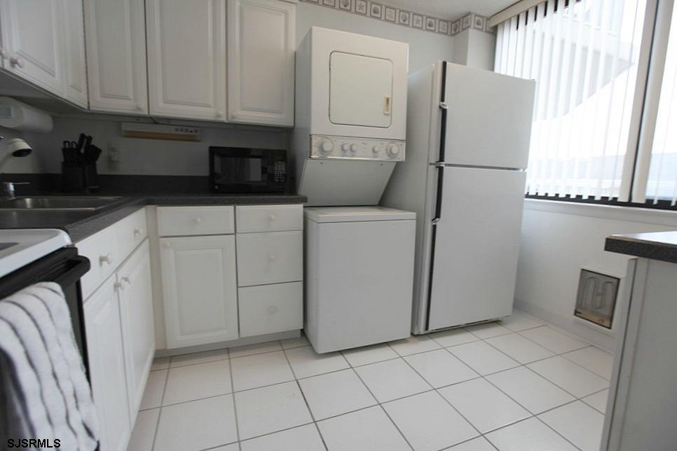 111 South 16th Avenue, Unit 312 Longport, NJ 08403 - Photo 8 of 14 a kitchen with a refrigerator sink and cabinets