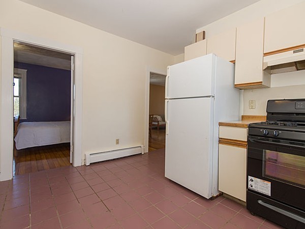 253 Sycamore Street, Unit 253 Watertown, MA 02472 - Photo 13 of 16 a white refrigerator freezer and a stove sitting inside of a kitchen